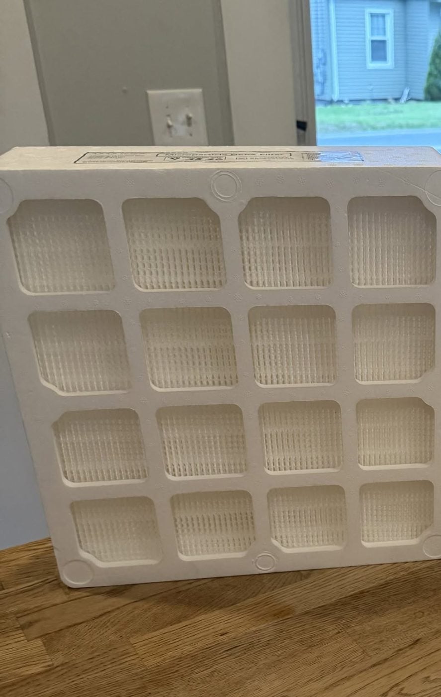 A clean, unused residential HVAC filter photographed beside the soiled one