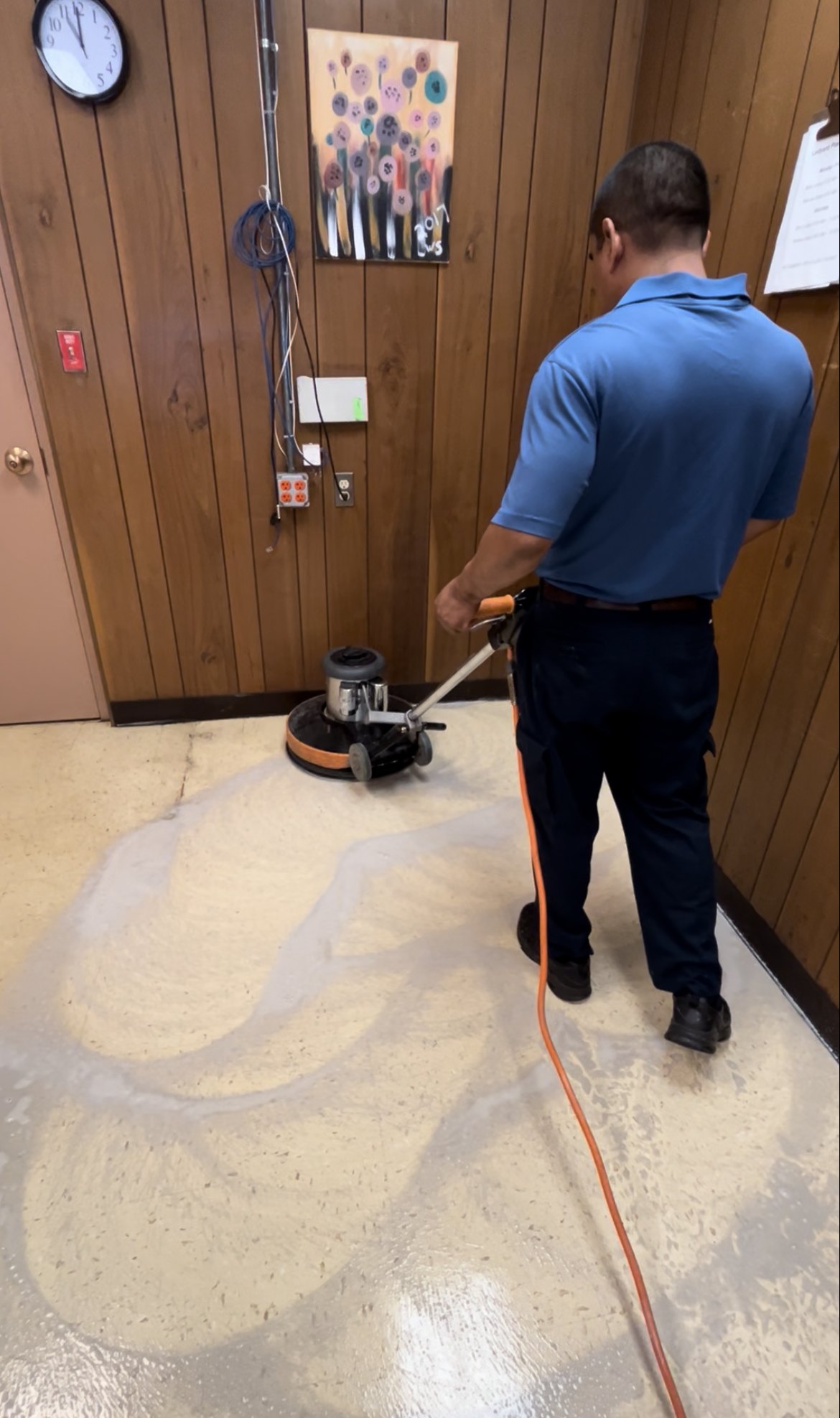 Technician buffing and cleaning a hard floor