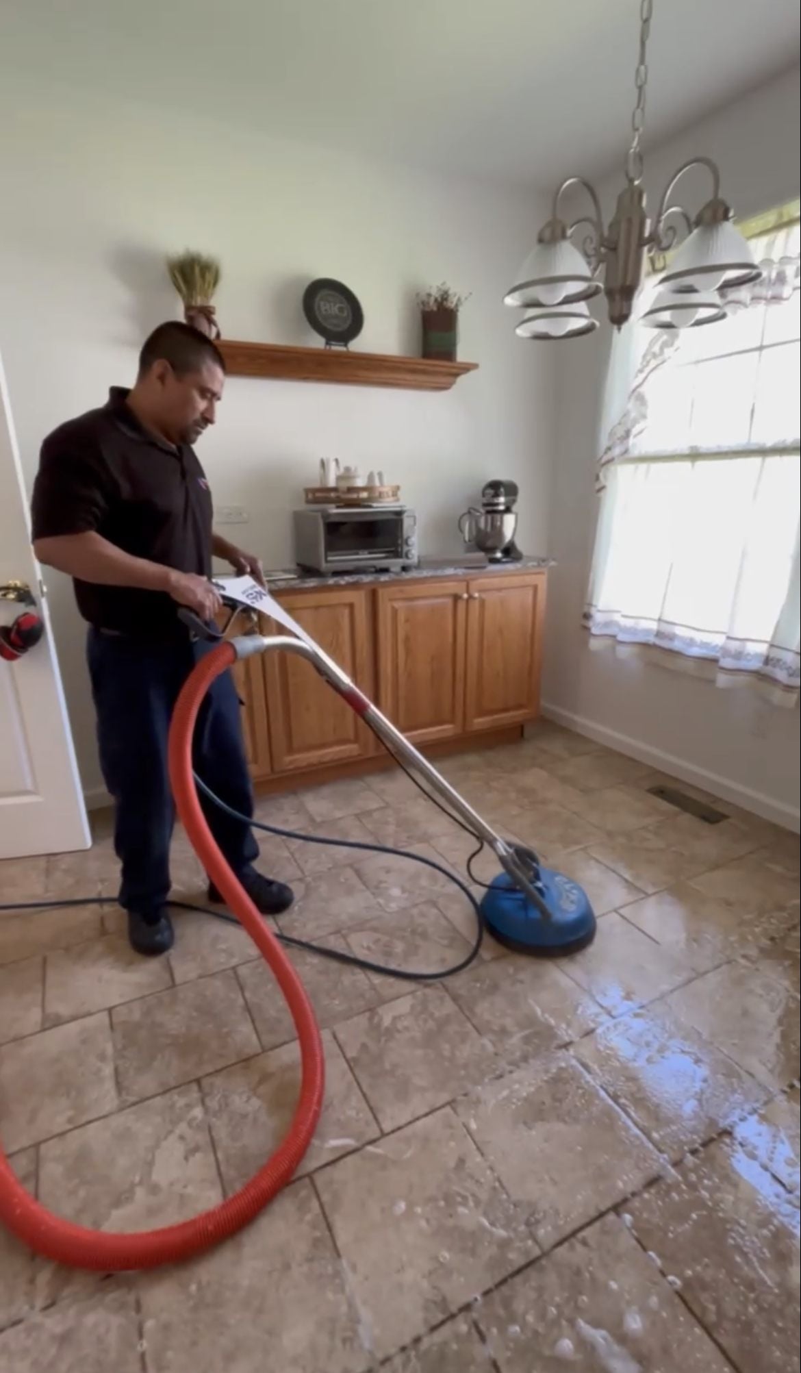 Technician cleaning a tile and grout floor in a Connecticut home