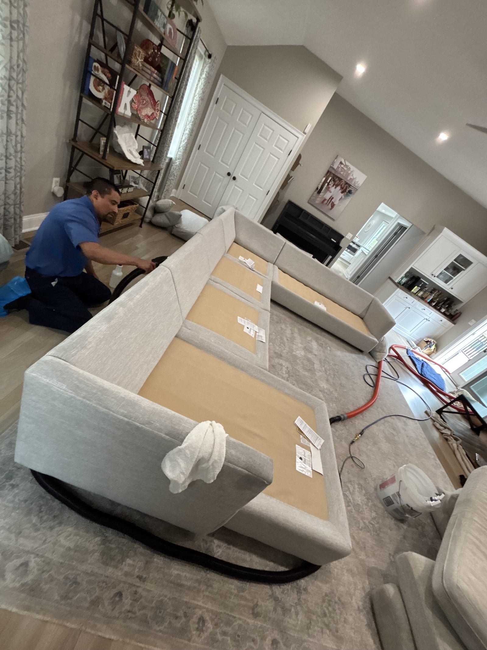 A PCRS technician cleaning an upholstered sofa