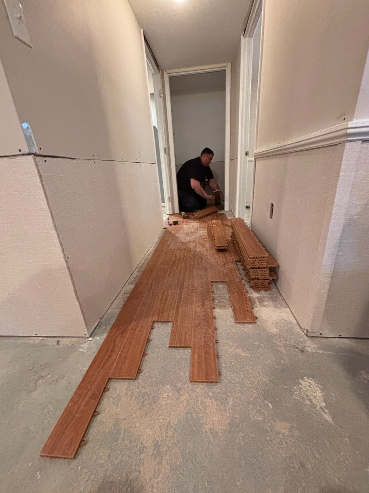 Technician working on a wood plank floor