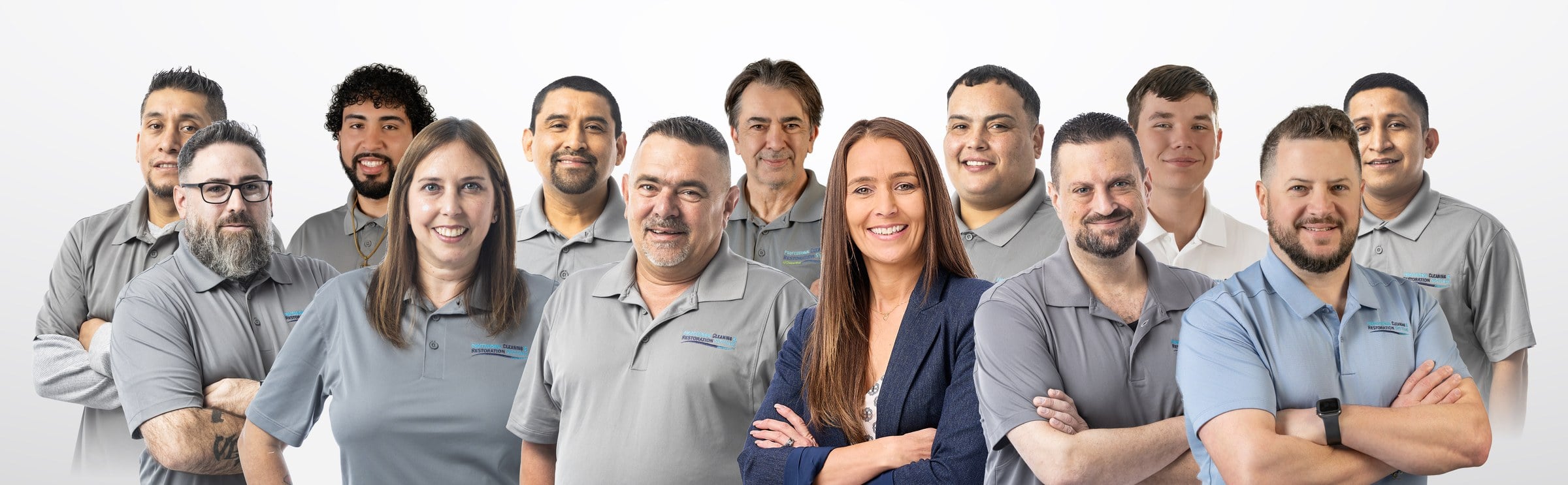 pcrs-team-lineup-web The Professional Cleaning & Restoration Systems team — technicians and office staff in branded polo shirts