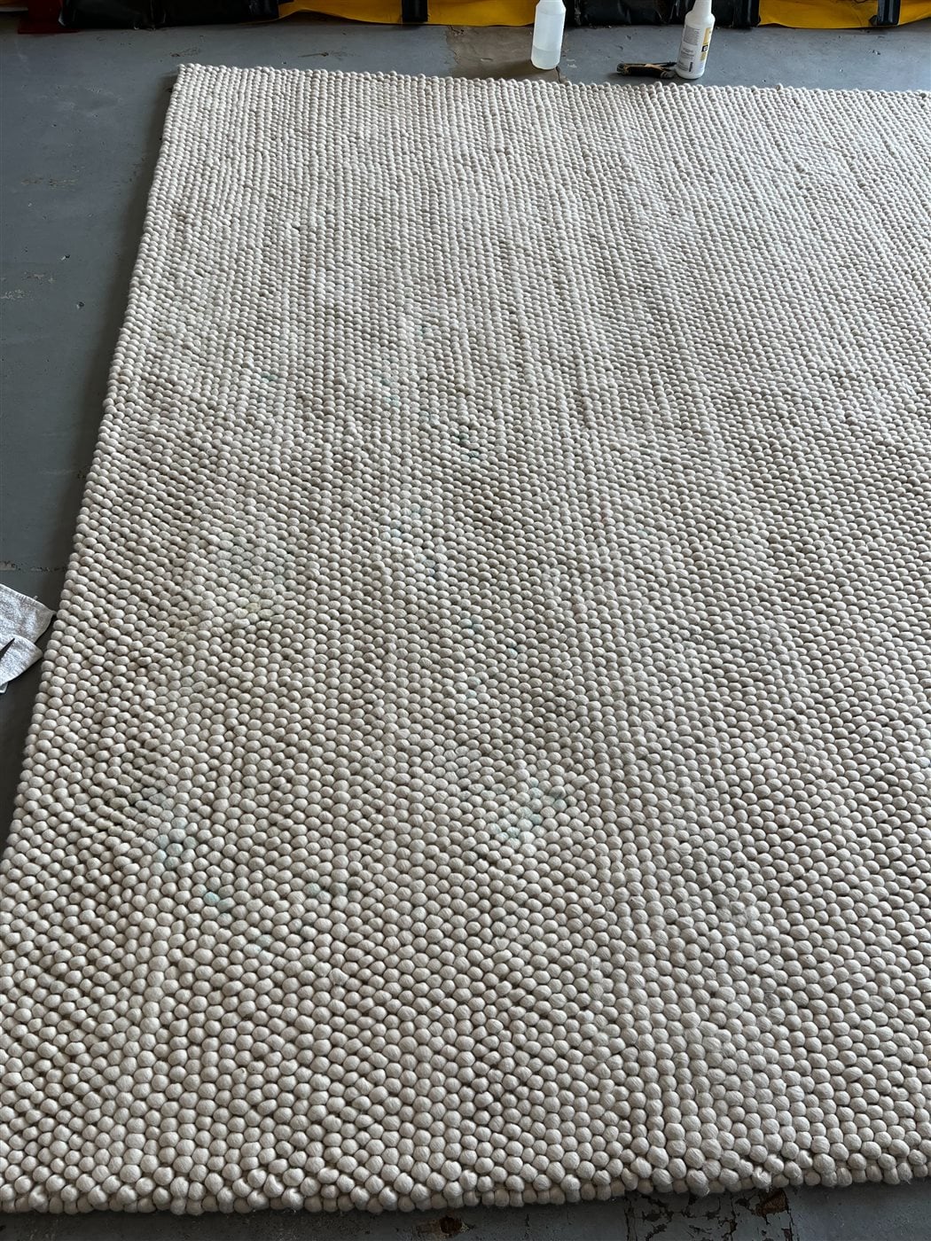 Wool felt-ball area rug after professional cleaning