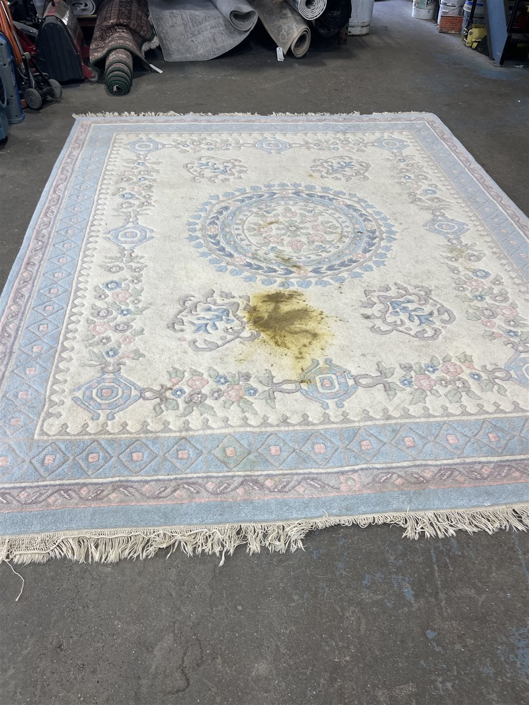 Area rug with a heavy stain before cleaning